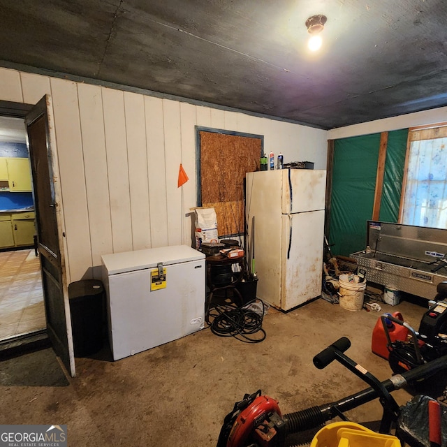 basement with white refrigerator and fridge