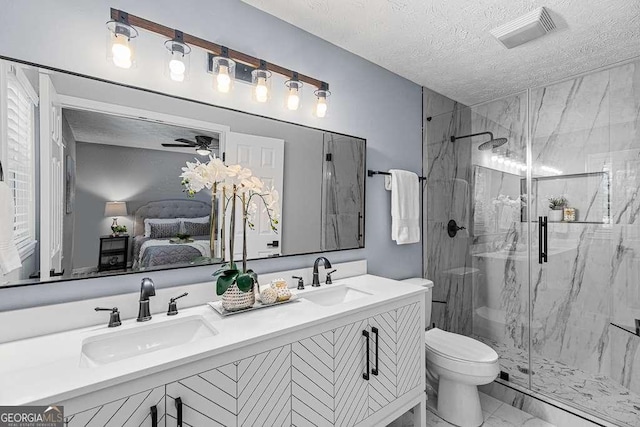 ensuite bathroom featuring marble finish floor, visible vents, a sink, and a marble finish shower