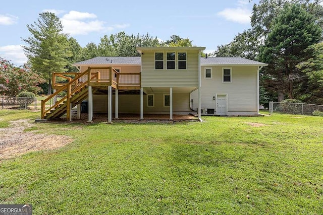 rear view of house featuring central AC, fence, a yard, stairway, and a wooden deck