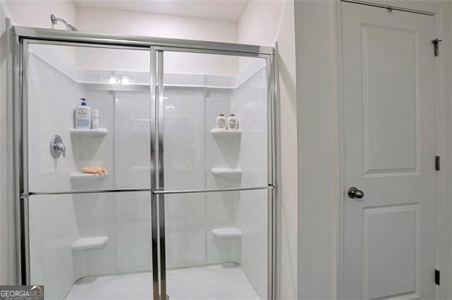 bathroom featuring a shower with door