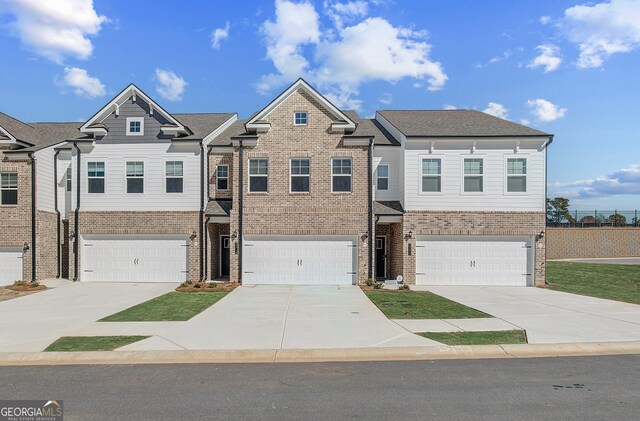 view of front of house featuring a garage and a front lawn