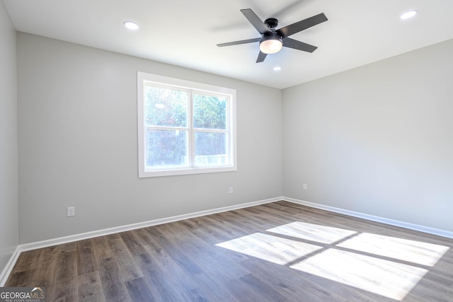 spare room with hardwood / wood-style flooring and ceiling fan