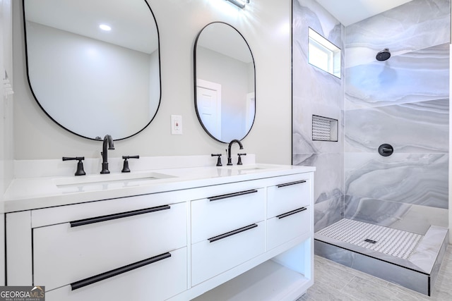 bathroom with vanity and tiled shower