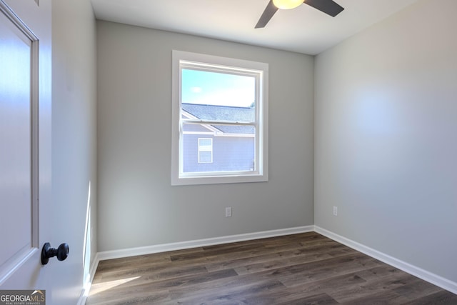 spare room with ceiling fan and dark hardwood / wood-style floors