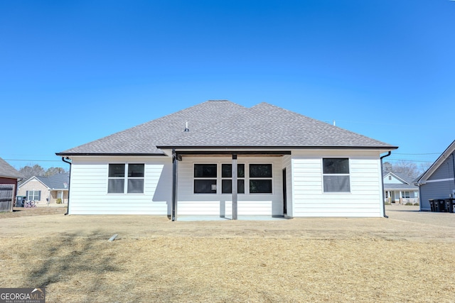 rear view of house featuring a lawn