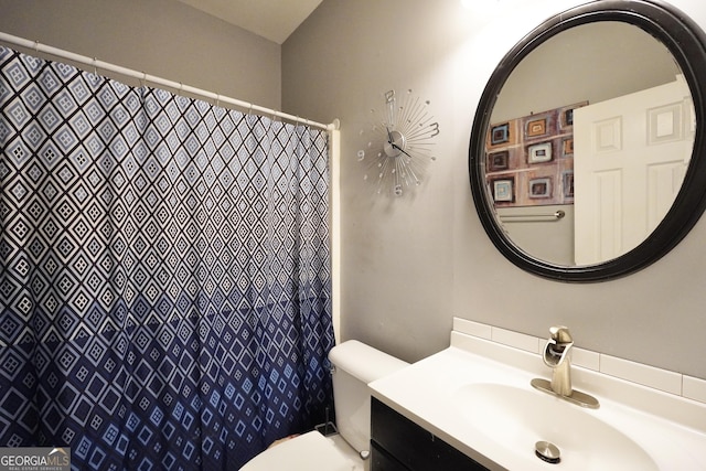 bathroom featuring vanity and toilet