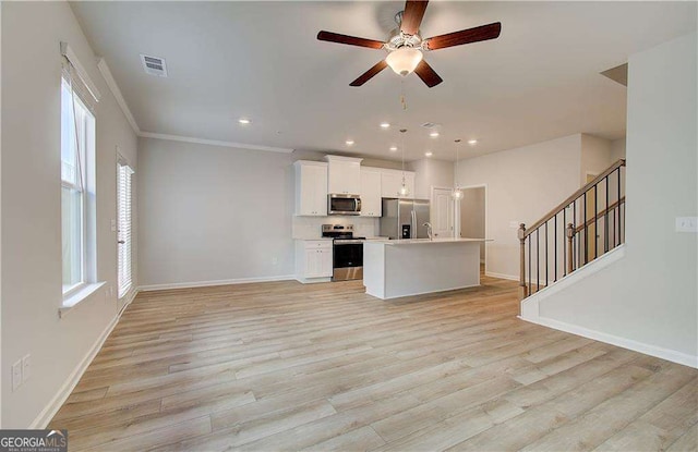 unfurnished living room with baseboards, visible vents, and light wood-style floors