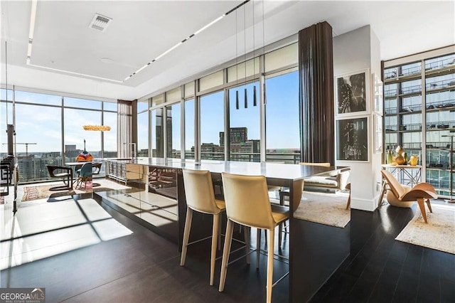 sunroom with visible vents and a city view