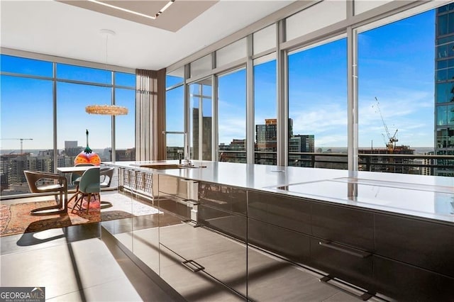 kitchen featuring floor to ceiling windows, sink, and tile patterned flooring