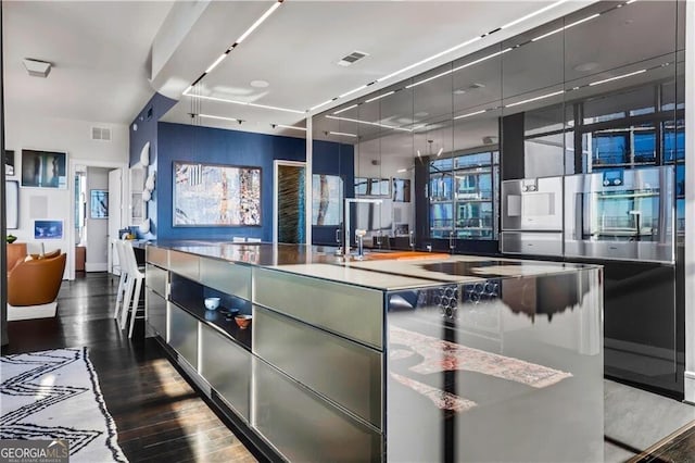 kitchen featuring modern cabinets, gray cabinets, dark wood-style floors, and visible vents