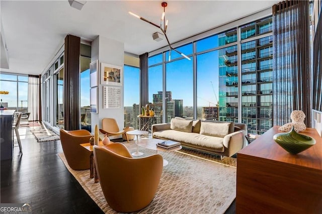 interior space featuring a city view, wood finished floors, and expansive windows