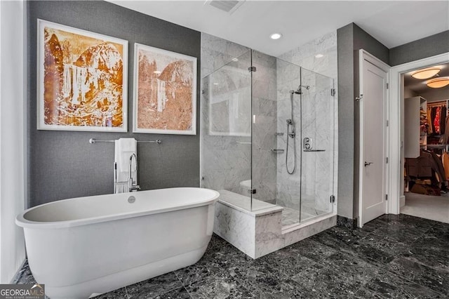 full bathroom with a soaking tub, recessed lighting, a stall shower, a walk in closet, and marble finish floor