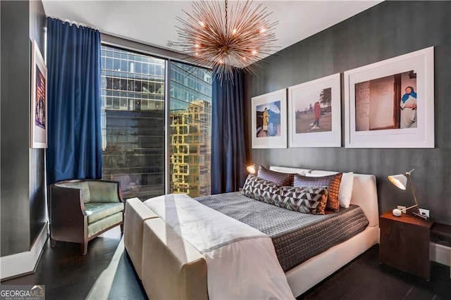 bedroom with an inviting chandelier and expansive windows