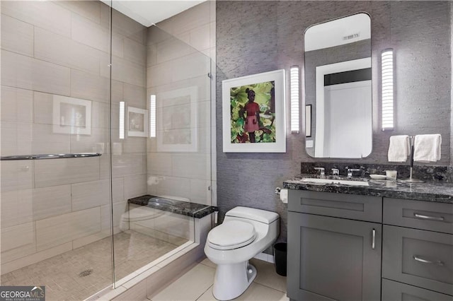 bathroom featuring vanity, toilet, walk in shower, and tile patterned floors