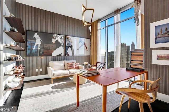 home office with a view of city, wood finished floors, baseboards, and expansive windows