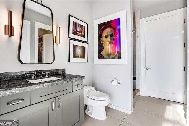 bathroom with vanity, toilet, a shower, and tile patterned flooring