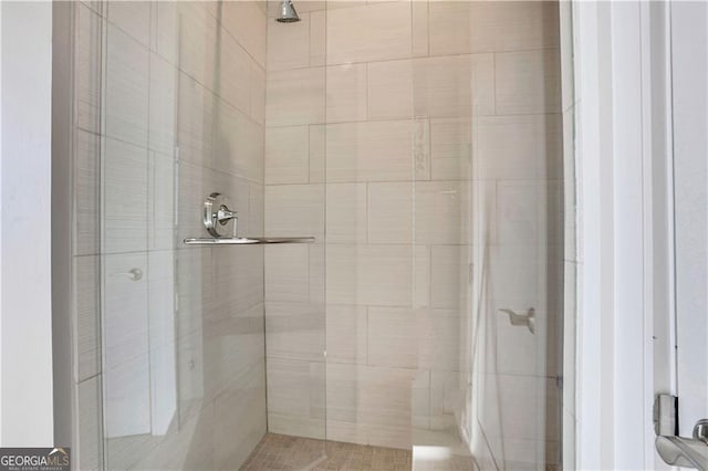 bathroom featuring a shower with shower door