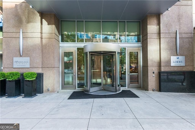 property entrance with stucco siding