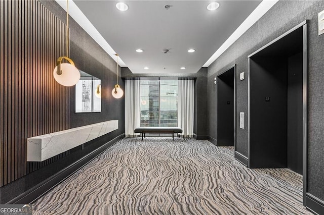 carpeted cinema room featuring elevator