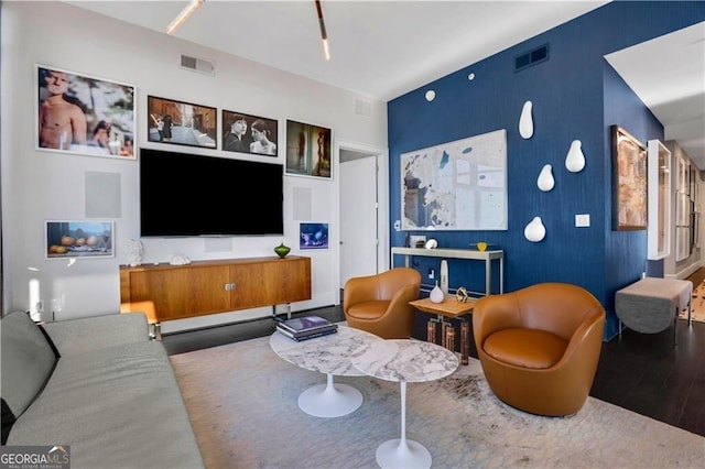 living room with visible vents and wood finished floors