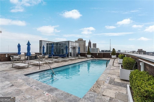 pool with a city view and a patio