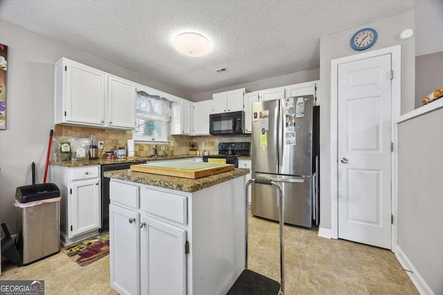 kitchen featuring black appliances, backsplash, a center island, and white cabinets