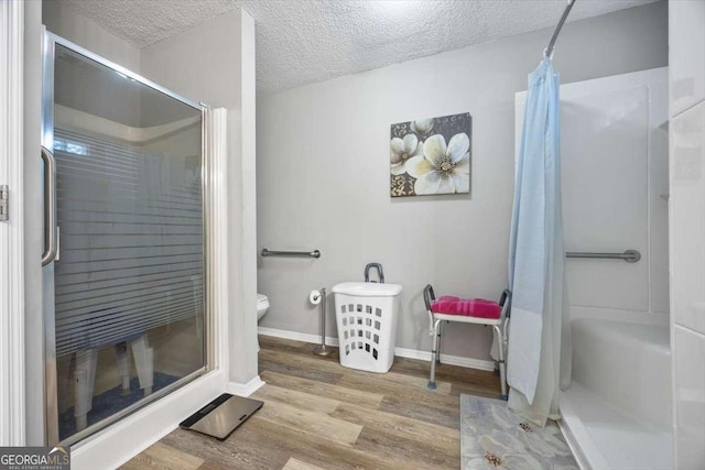 bathroom with hardwood / wood-style flooring, curtained shower, a textured ceiling, and toilet