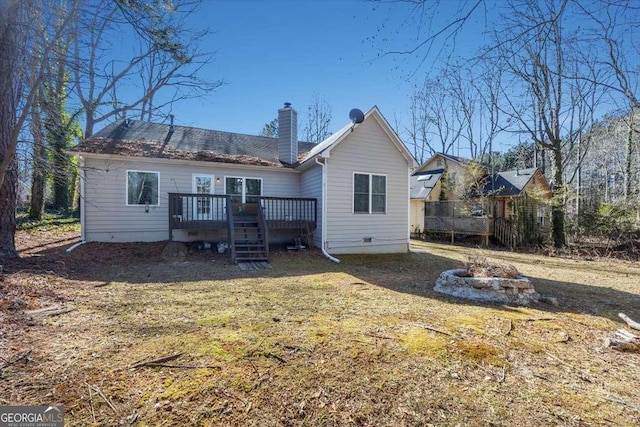 rear view of house featuring an outdoor fire pit and a deck