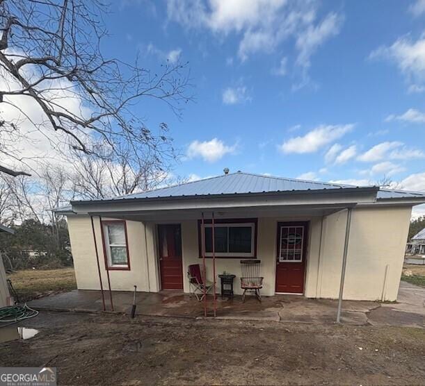 rear view of property with a porch