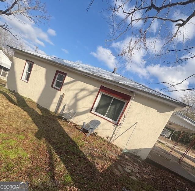 view of side of home with a lawn