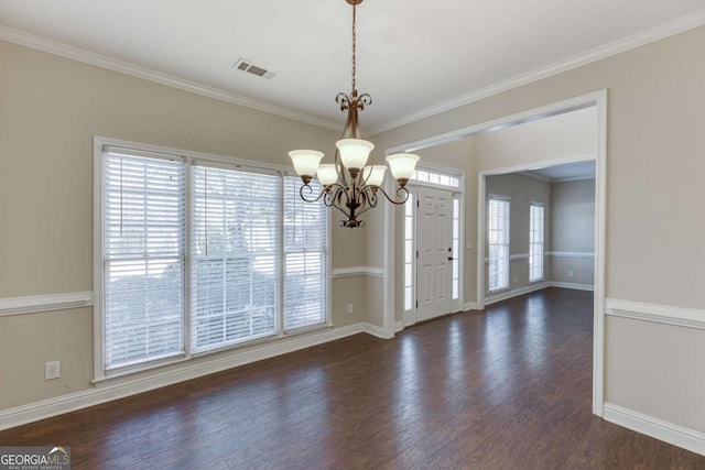 interior space featuring a chandelier, ornamental molding, and dark wood-type flooring