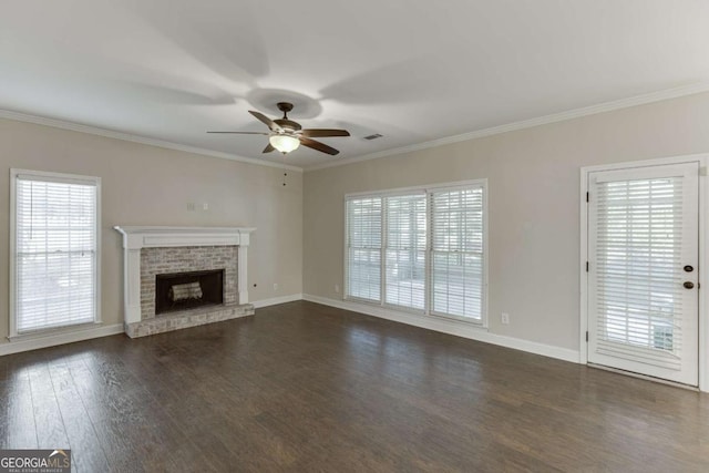 unfurnished living room with ceiling fan, dark hardwood / wood-style flooring, crown molding, and a fireplace