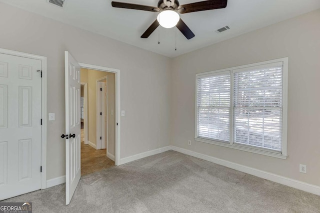 unfurnished room with light colored carpet