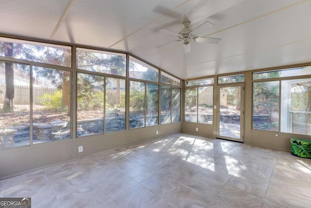 unfurnished sunroom with ceiling fan and vaulted ceiling