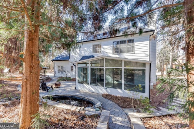 back of house with a sunroom and a patio