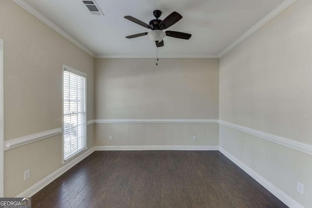 spare room with crown molding, dark wood-type flooring, and ceiling fan