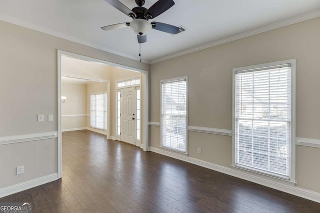 interior space with ceiling fan, dark hardwood / wood-style floors, ornamental molding, and plenty of natural light