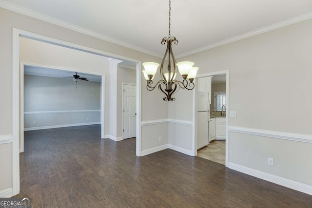 unfurnished dining area featuring ceiling fan with notable chandelier, crown molding, and dark hardwood / wood-style floors