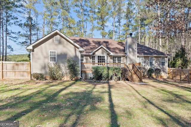 view of front of home featuring a deck and a front yard