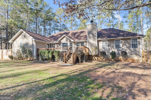 rear view of house with a lawn and a deck