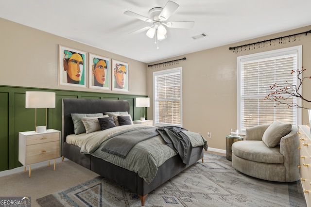 bedroom with light carpet and ceiling fan