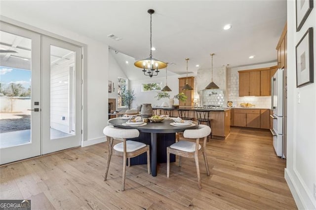 dining area featuring light hardwood / wood-style floors, a healthy amount of sunlight, and french doors