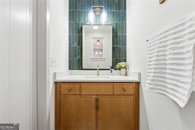 bathroom featuring vanity and tile walls