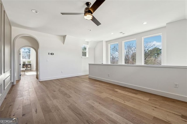 unfurnished living room with light hardwood / wood-style floors and ceiling fan