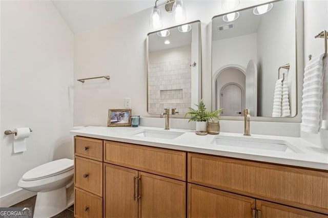 bathroom with toilet and vanity