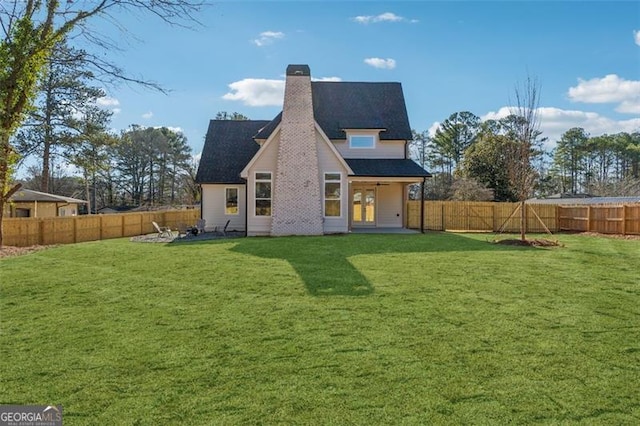 rear view of property with a patio area and a lawn