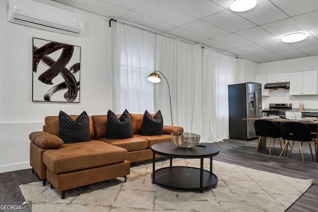 living room featuring a wall mounted AC and dark hardwood / wood-style flooring