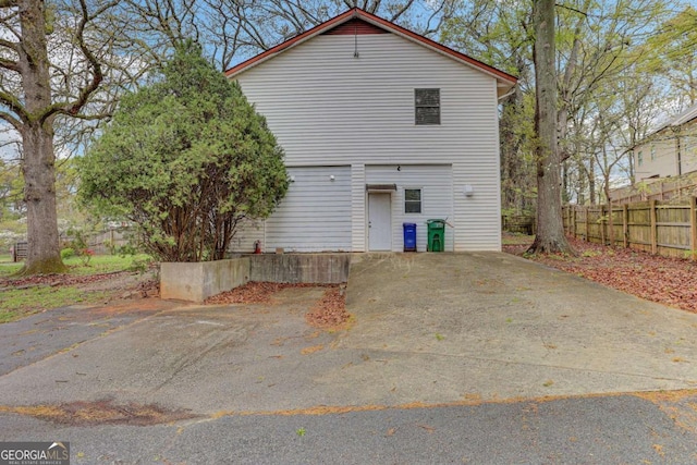 back of property with a garage