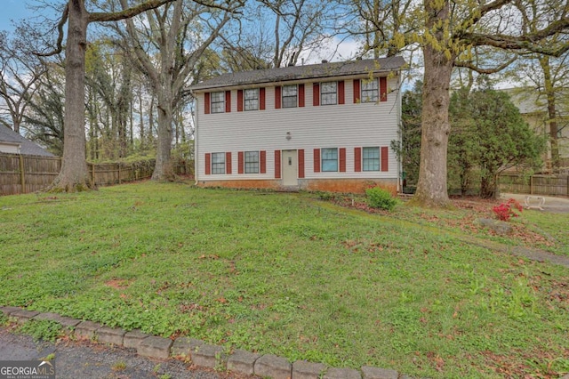 colonial inspired home featuring a front lawn