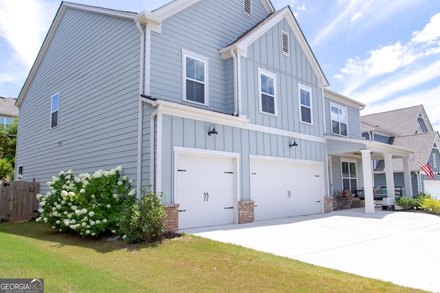 view of front of property with a porch, a garage, and a front yard